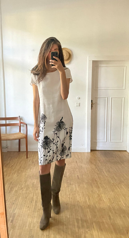 White linen summer dress with a black floral pattern,