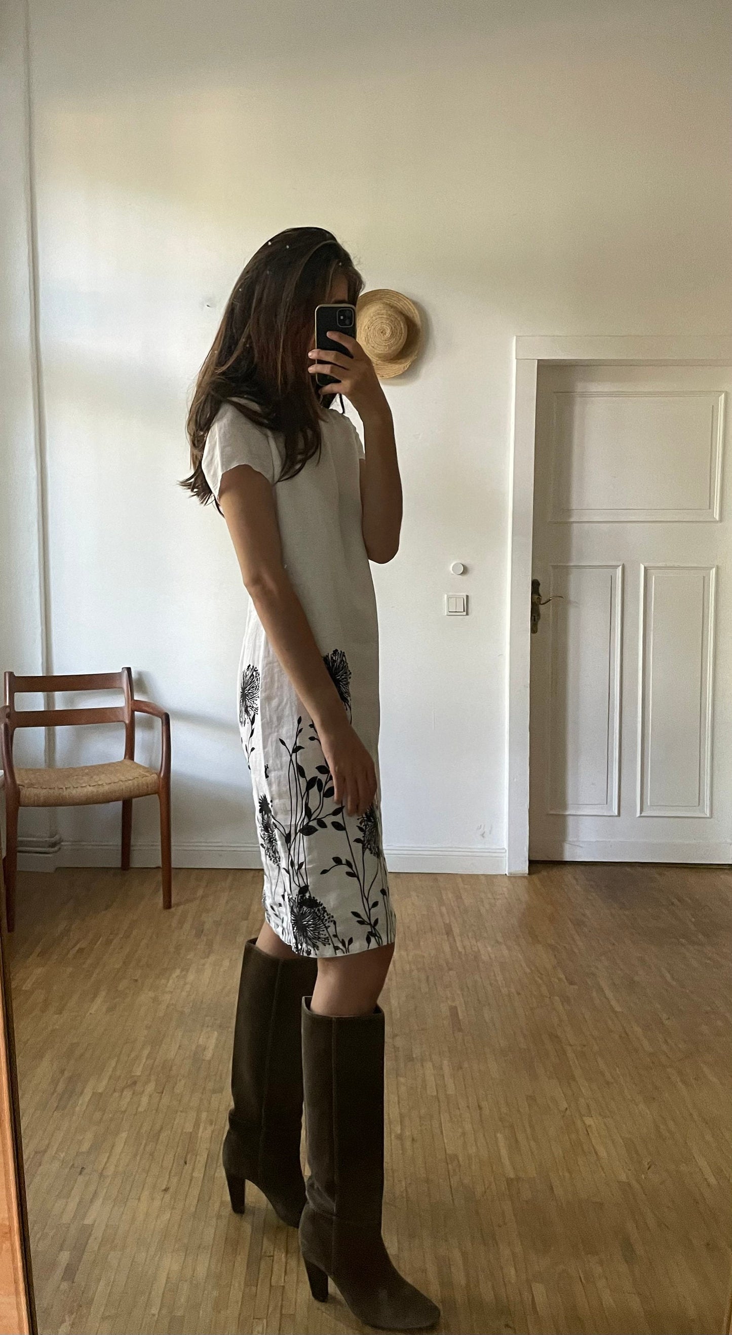 White linen summer dress with a black floral pattern,