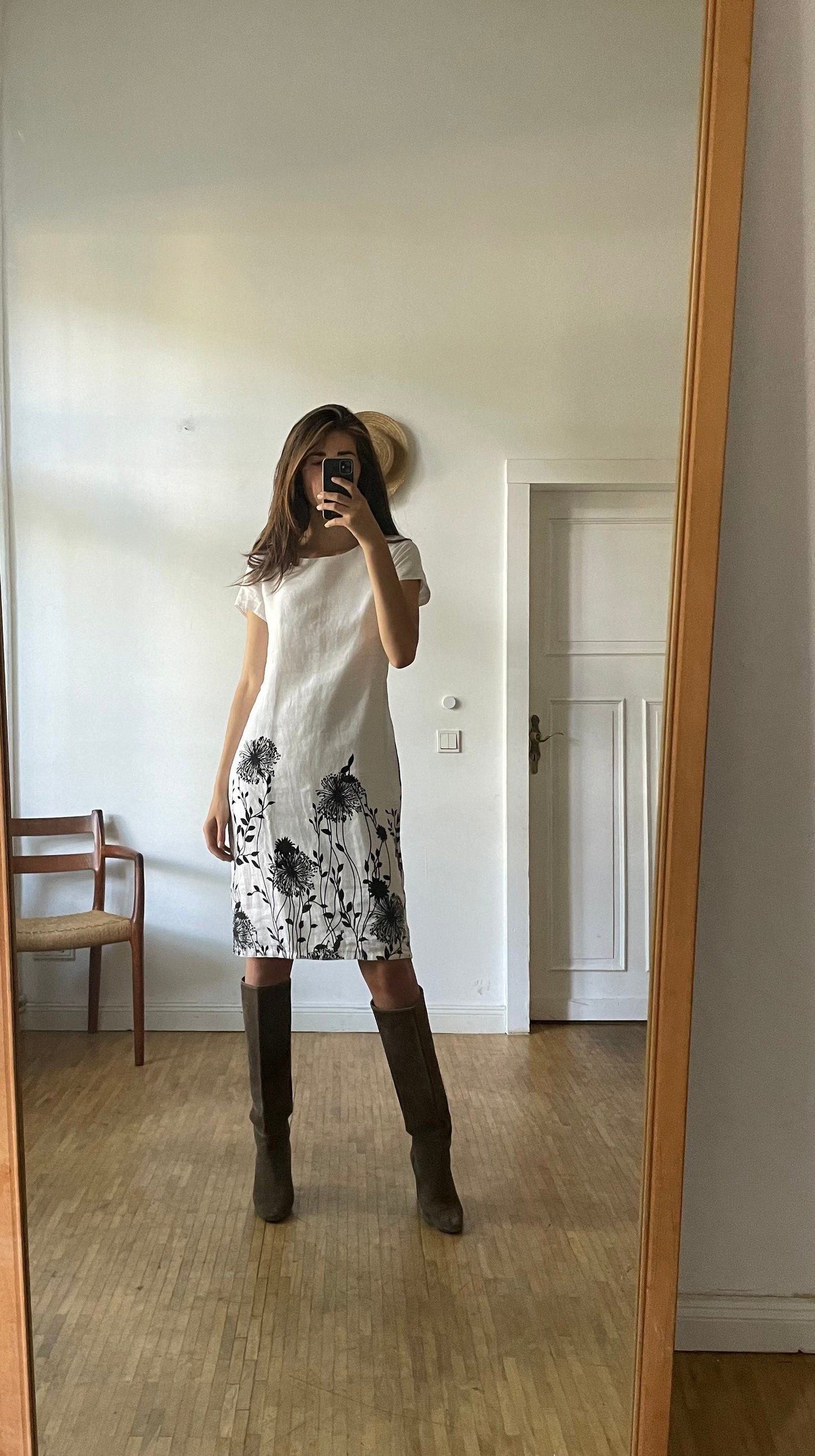 White linen summer dress with a black floral pattern,