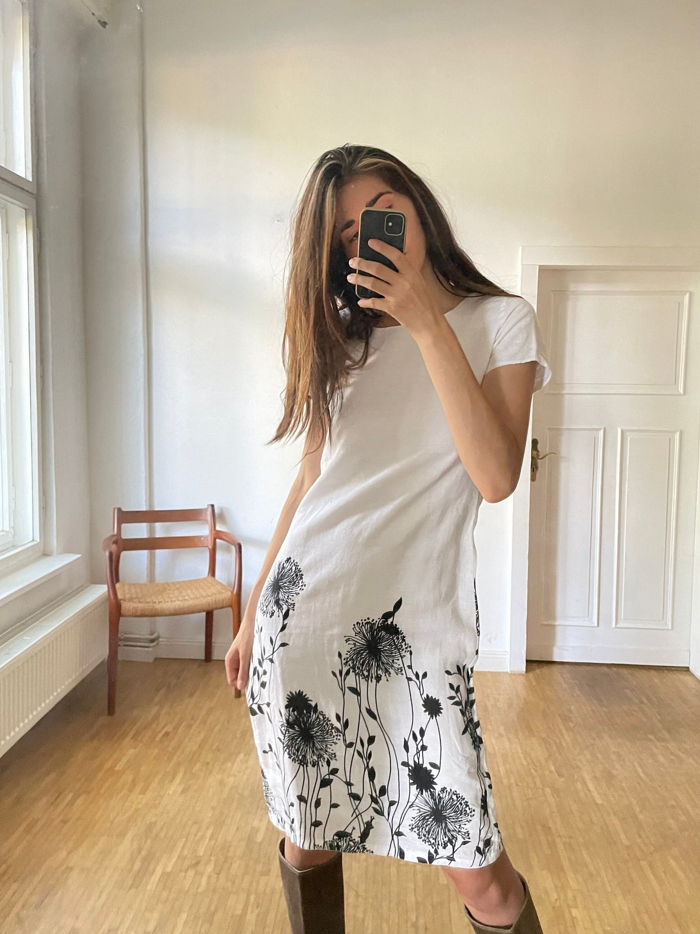 White linen summer dress with a black floral pattern,