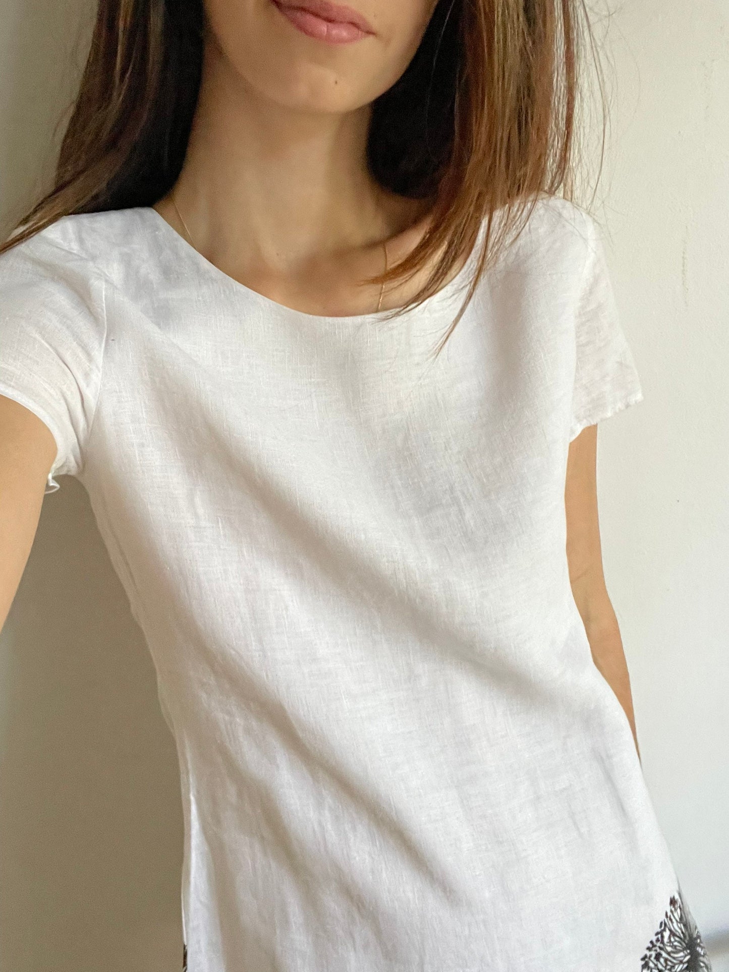 White linen summer dress with a black floral pattern,