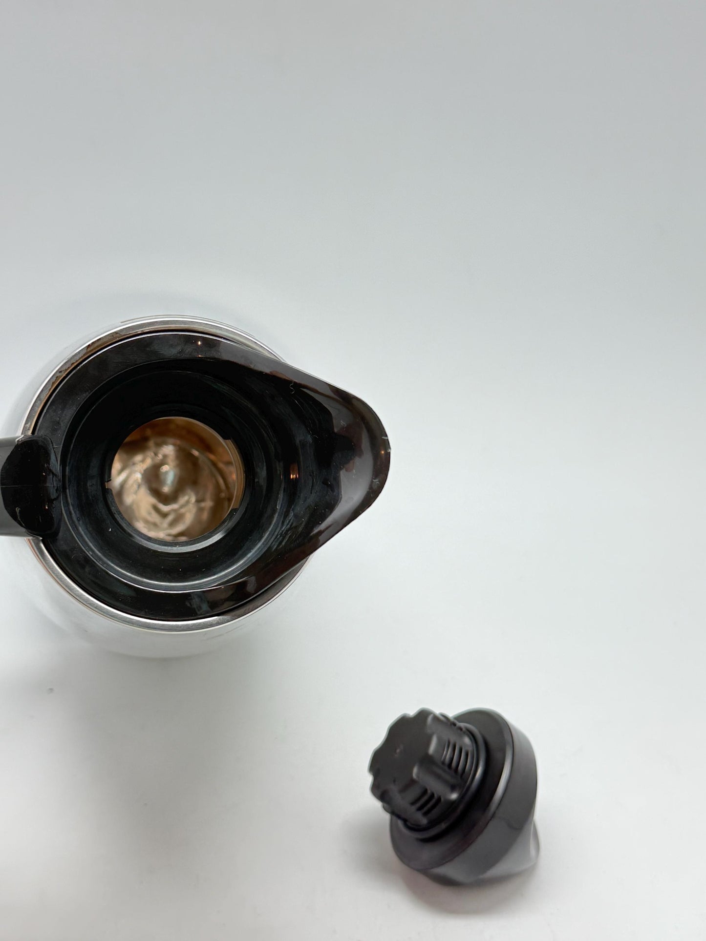 Modern stainless steel thermal carafe, double, wall insulation, sleek reflective finish, ergonomic handle, minimalist chic vibe