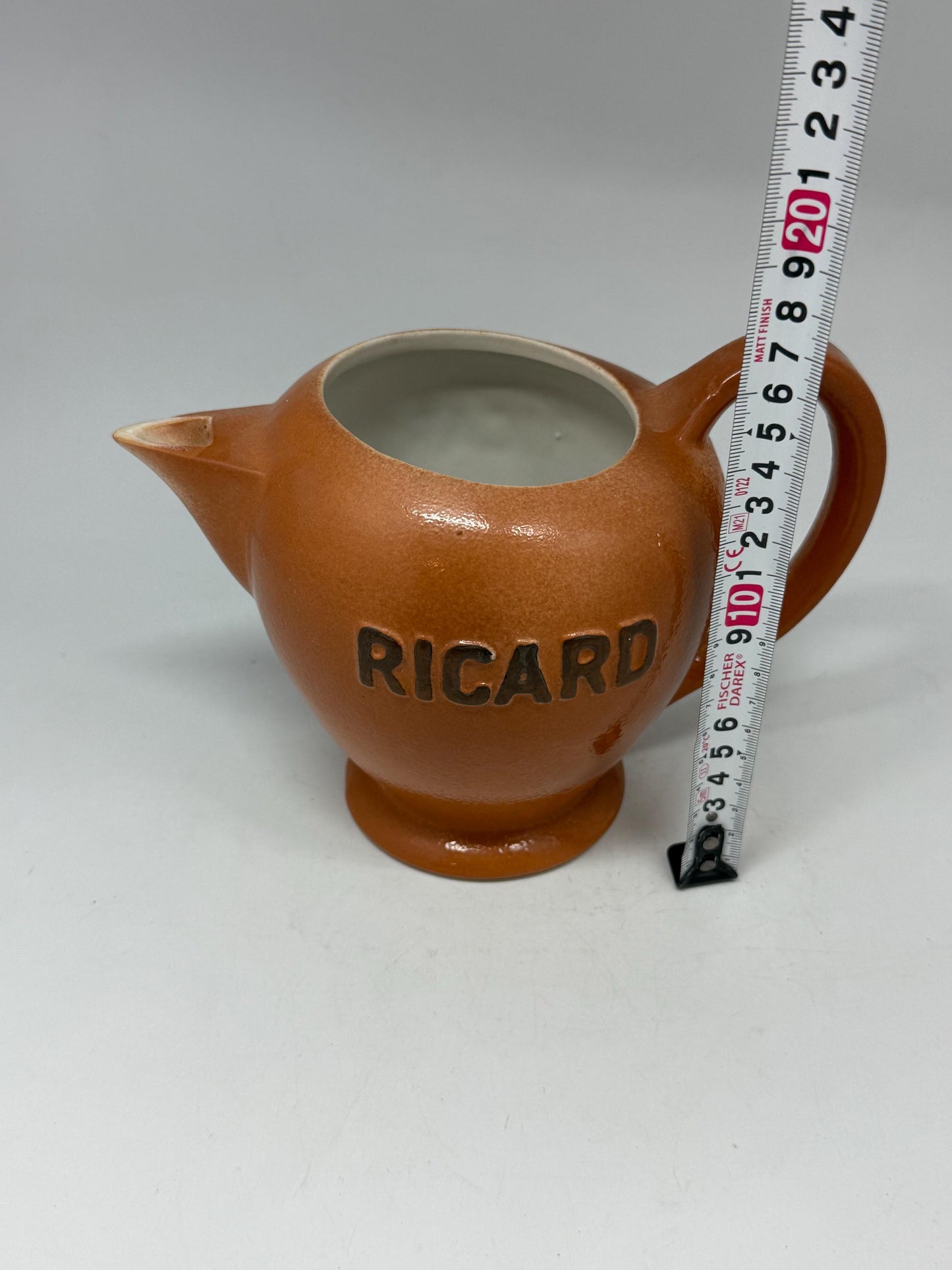 Vintage terracotta Ricard pitcher, ceramic feel, rounded glossy body, iconic branding, retro 80s vibe, tabletop decor