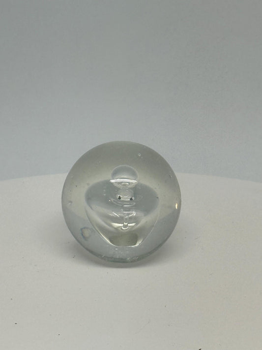Clear glass sphere, artistic design, smooth surface, slight bubble inclusions, minimalist, elegant decor, office or home accent