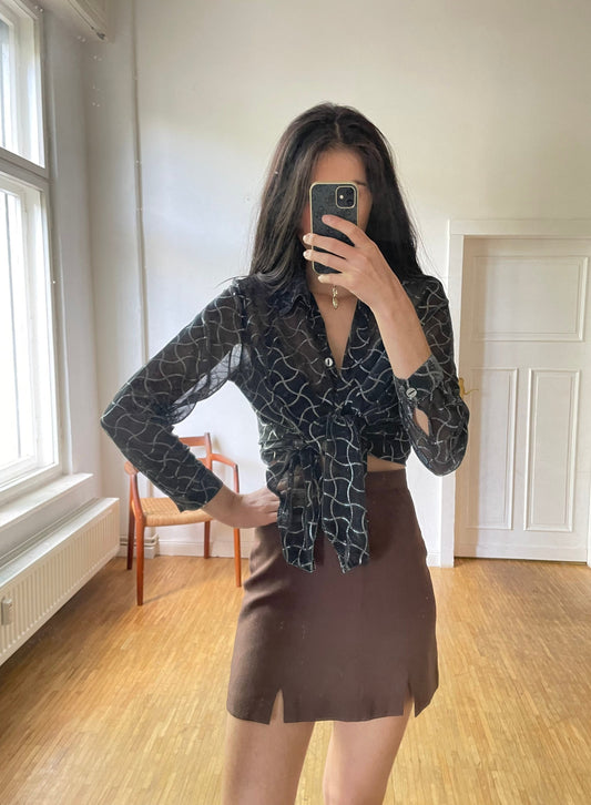 Vintage see through black blouse with shiny silver detailed pattern.