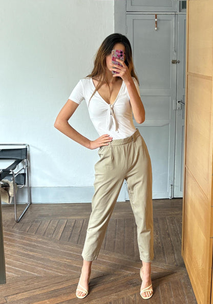 Vintage High-Waisted Beige Tapered Trousers — fabric close-up