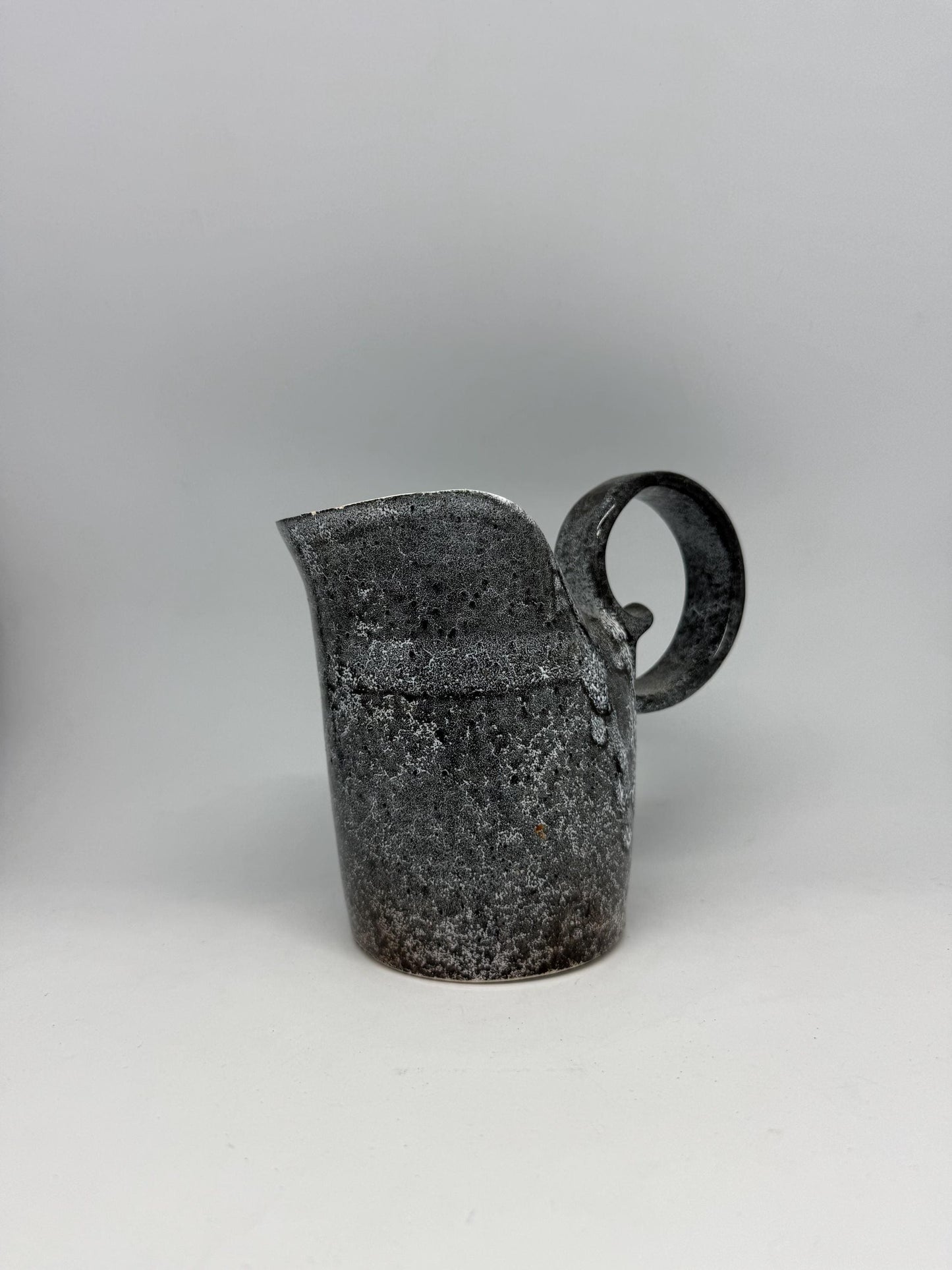 Vintage charcoal speckled ceramic creamer pitcher – sculptural swirl handle – 15cm tall – 10cm top width – rustic kitchen decor