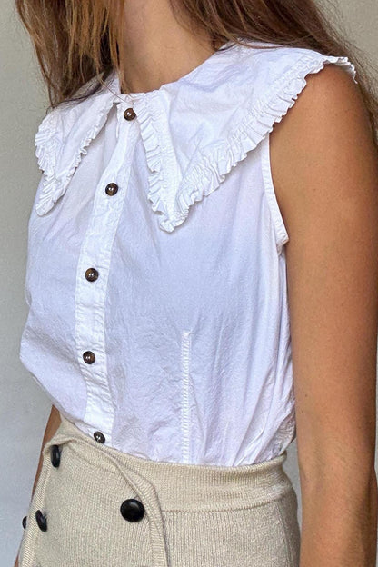 Ganni White Ruffle Collar Sleeveless Blouse — fabric close-up