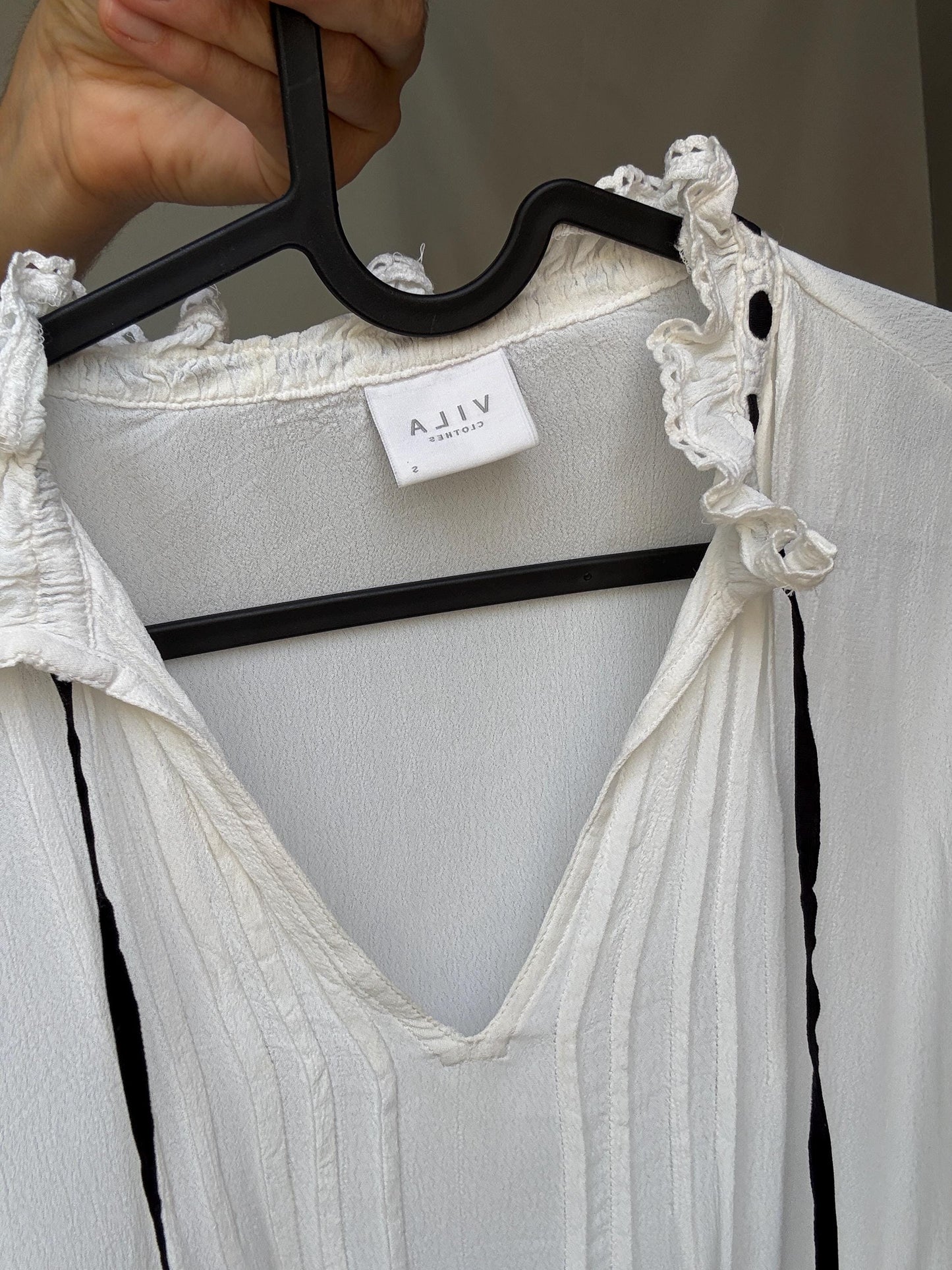 Romantic Bohemian White Blouse with Black Tie Detailing, Flowing Sleeves, and Ruffled V-Neck Inspired by Alexa Chung Style