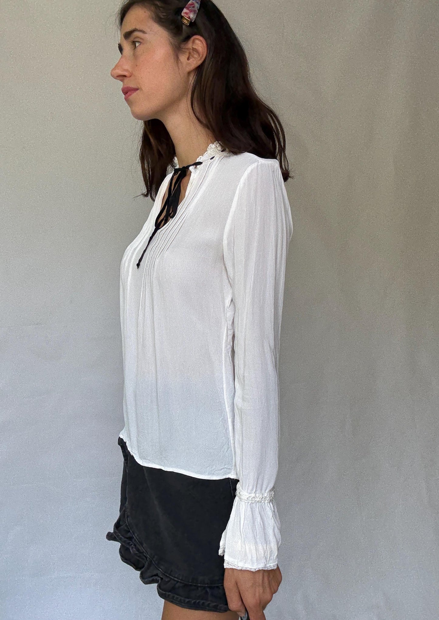 Romantic Bohemian White Blouse with Black Tie Detailing, Flowing Sleeves, and Ruffled V-Neck Inspired by Alexa Chung Style