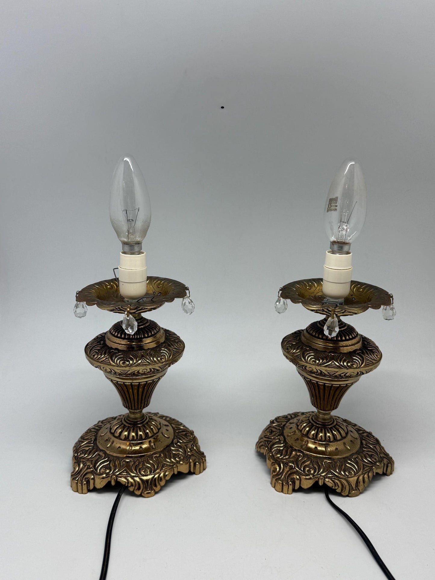 Vintage pair of ornate table lamps, metal with brass, tone finish, candle holders, hanging crystal accents, elegant antique style