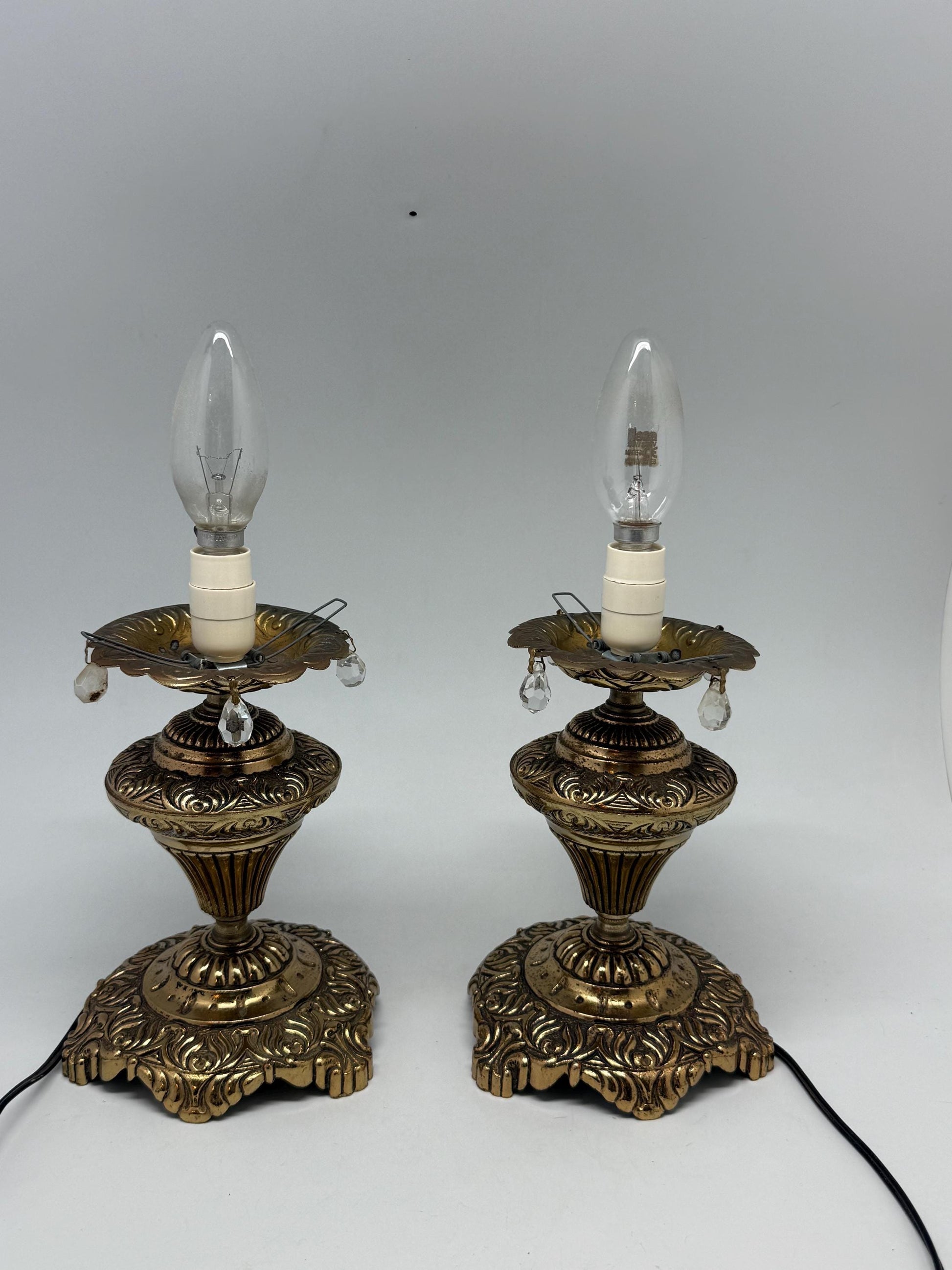 Vintage pair of ornate table lamps, metal with brass, tone finish, candle holders, hanging crystal accents, elegant antique style