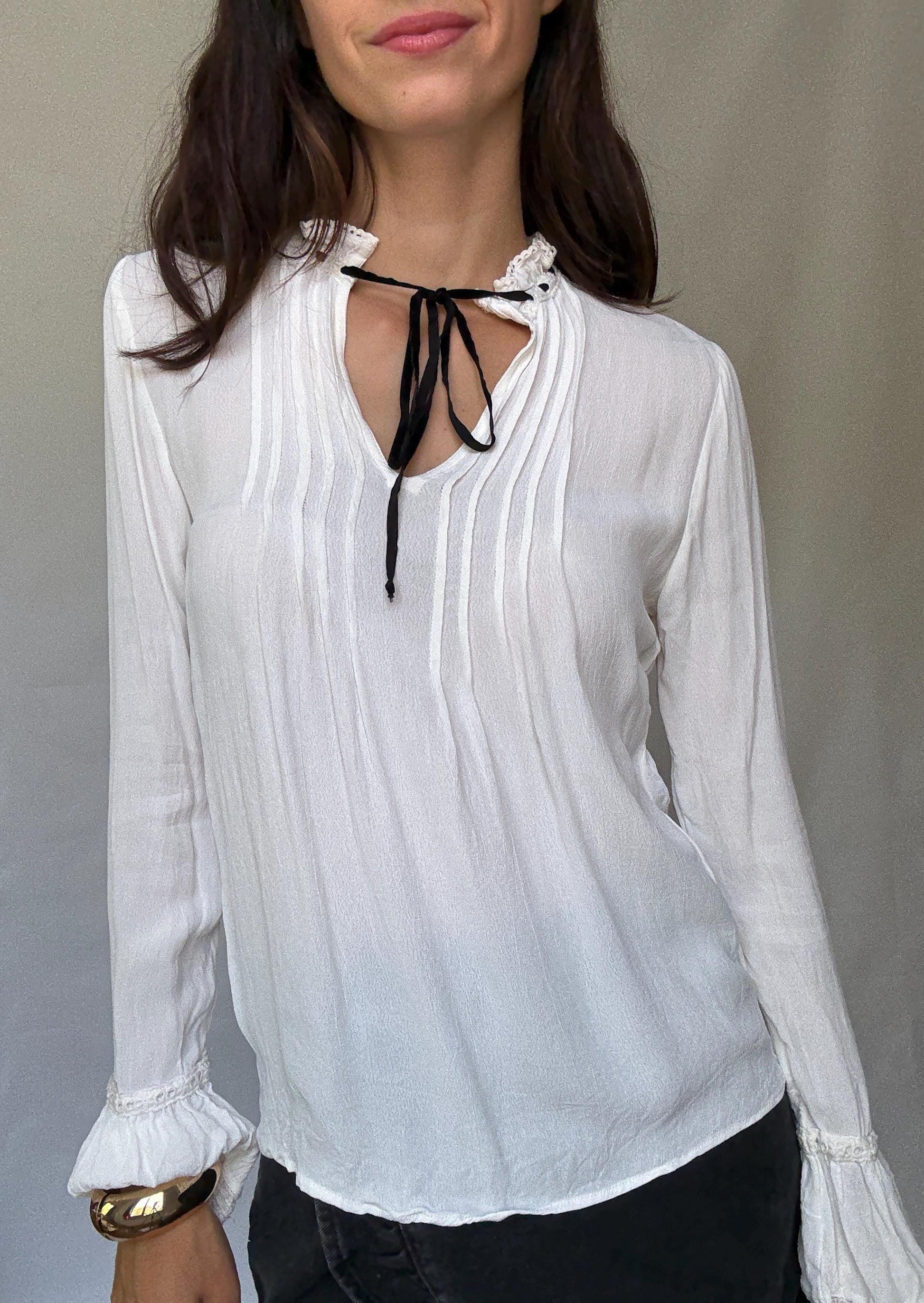 Romantic Bohemian White Blouse with Black Tie Detailing, Flowing Sleeves, and Ruffled V-Neck Inspired by Alexa Chung Style