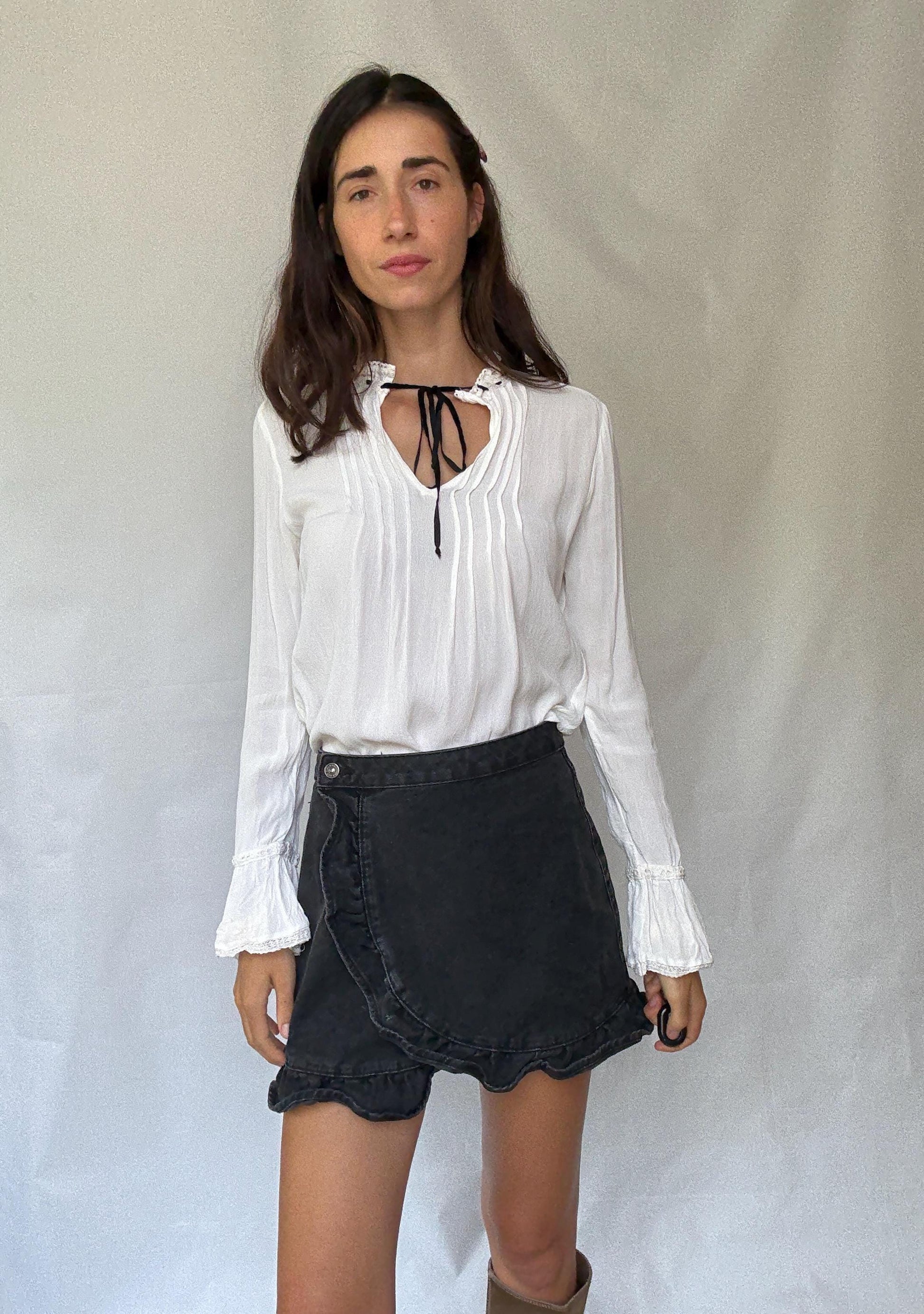 Romantic Bohemian White Blouse with Black Tie Detailing, Flowing Sleeves, and Ruffled V-Neck Inspired by Alexa Chung Style