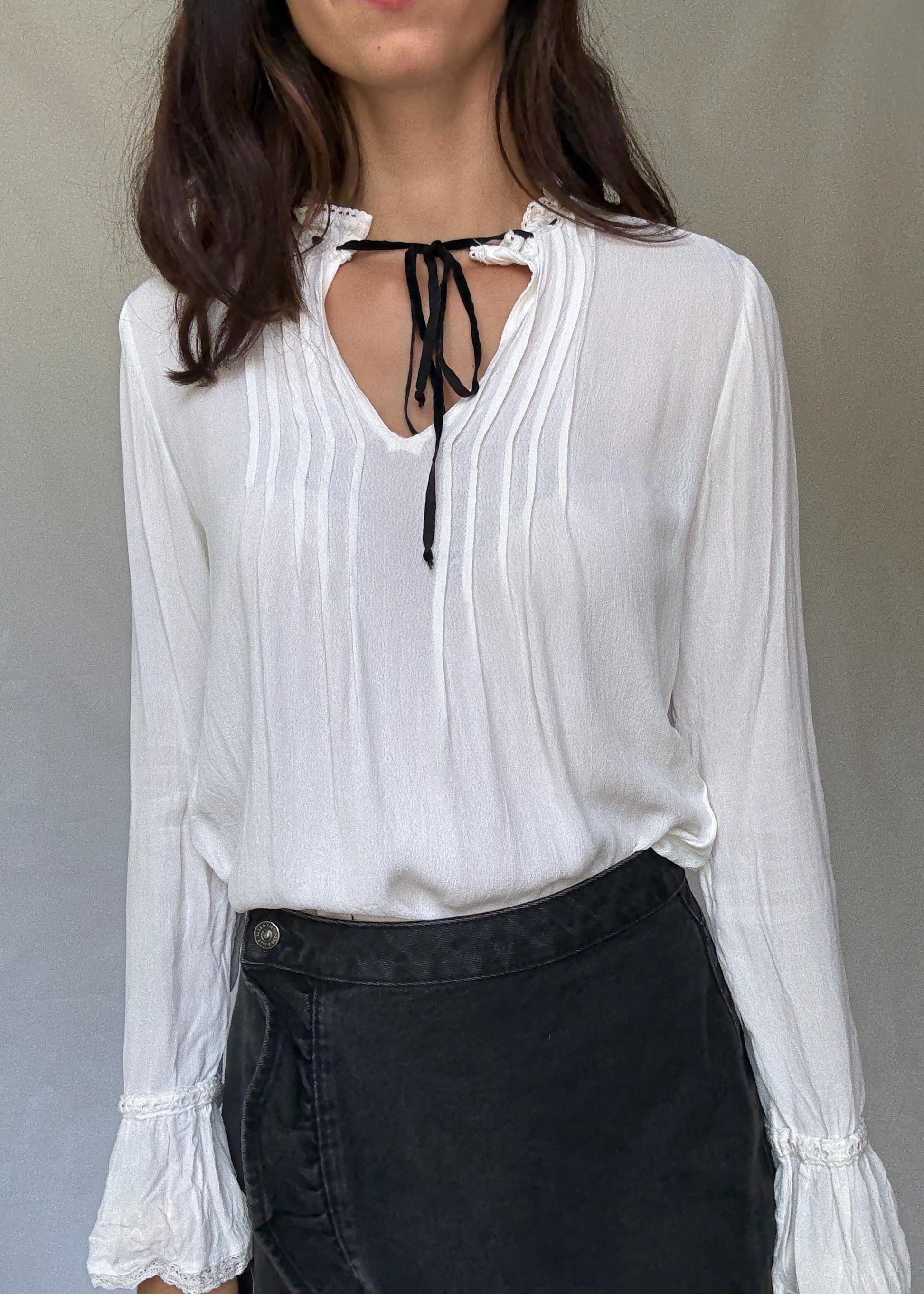 Romantic Bohemian White Blouse with Black Tie Detailing, Flowing Sleeves, and Ruffled V-Neck Inspired by Alexa Chung Style