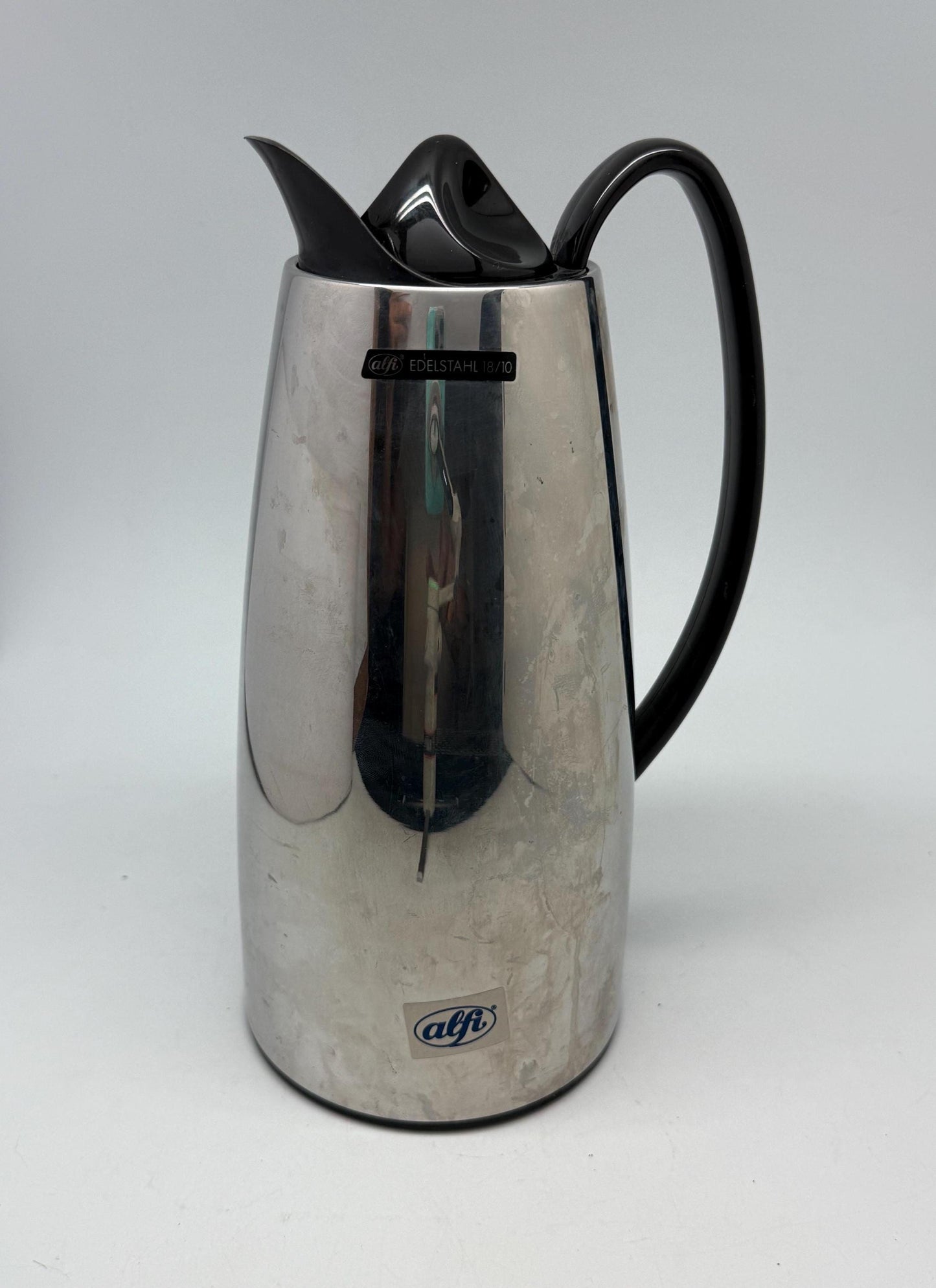 Modern stainless steel thermal carafe, double, wall insulation, sleek reflective finish, ergonomic handle, minimalist chic vibe