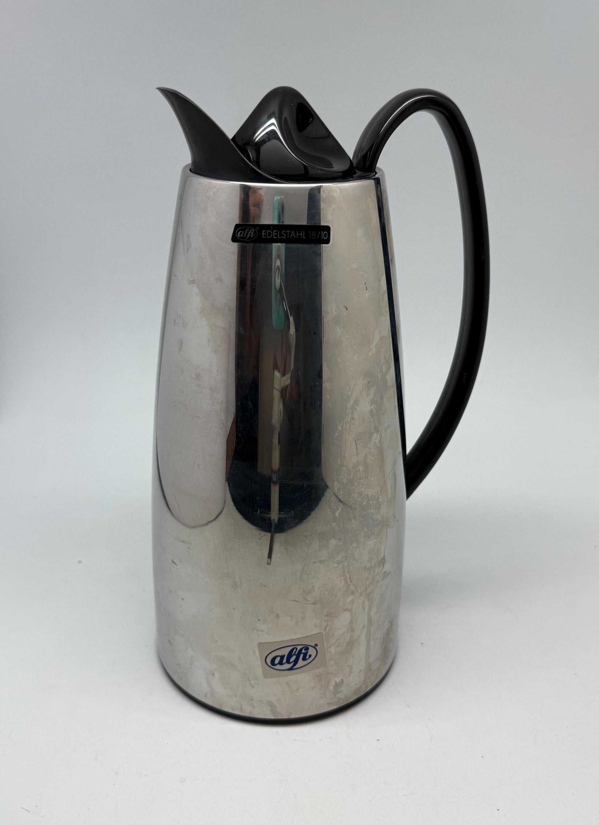 Modern stainless steel thermal carafe, double, wall insulation, sleek reflective finish, ergonomic handle, minimalist chic vibe