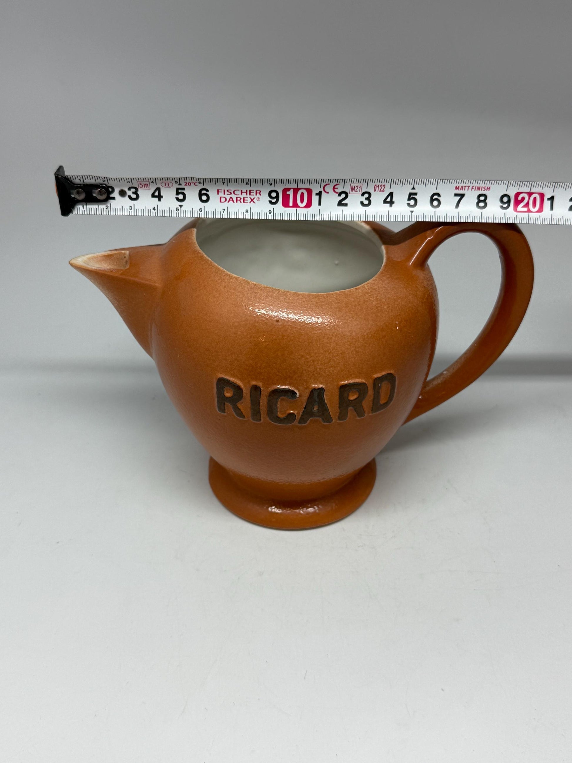 Vintage terracotta Ricard pitcher, ceramic feel, rounded glossy body, iconic branding, retro 80s vibe, tabletop decor