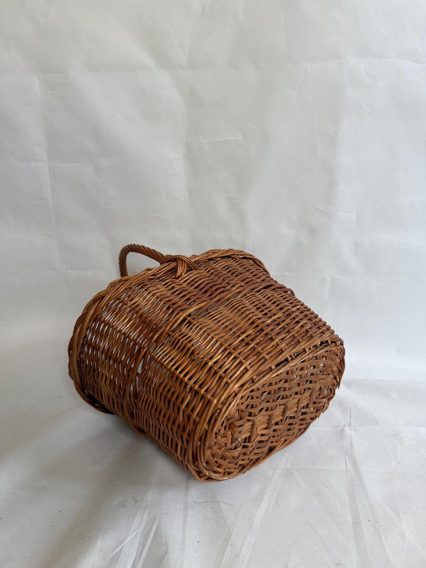 Rustic rattan basket, natural woven design, classic silhouette, autumn basket, crisscross pattern, rustic charm, picnic or storage