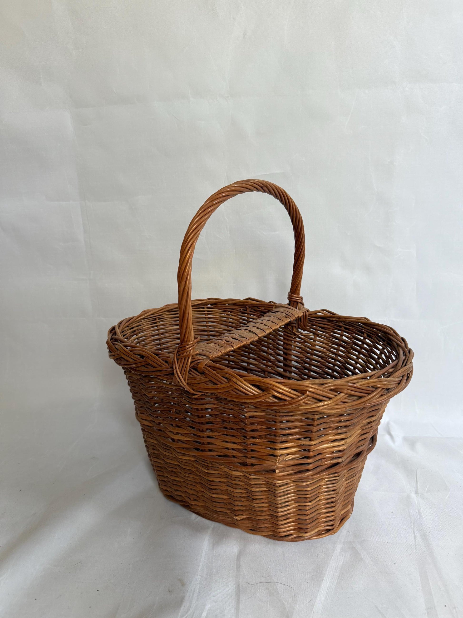 Rustic rattan basket, natural woven design, classic silhouette, autumn basket, crisscross pattern, rustic charm, picnic or storage