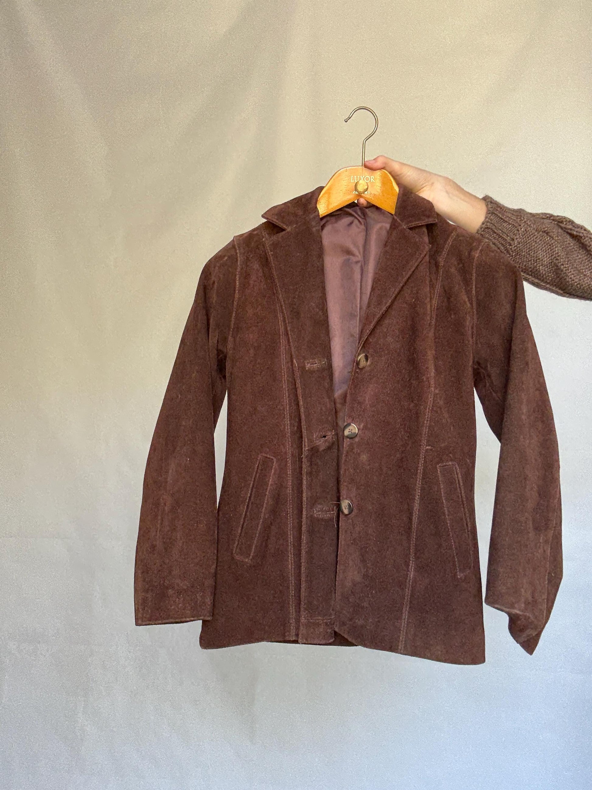 Vintage brown leather jacket, fitted silhouette, button closures, seam detailing, retro 70s vibe, US M, versatile classic style