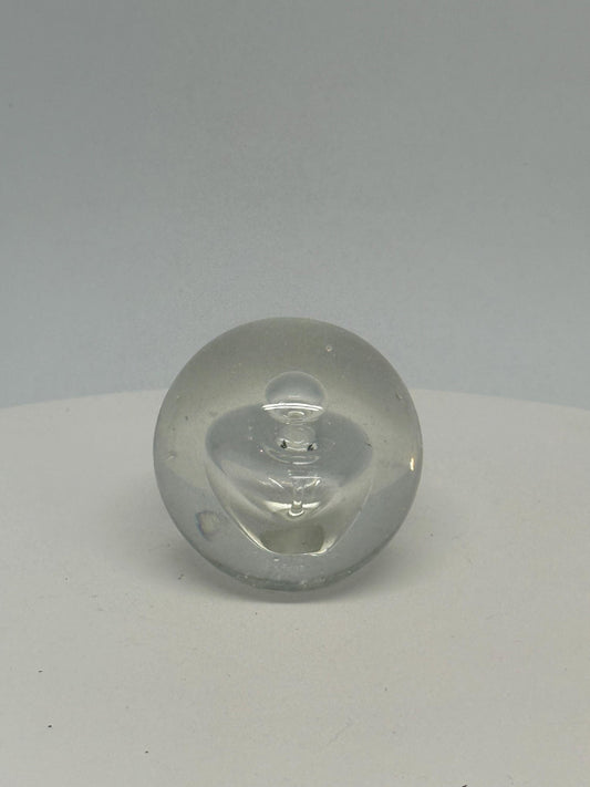 Clear glass sphere, artistic design, smooth surface, slight bubble inclusions, minimalist, elegant decor, office or home accent