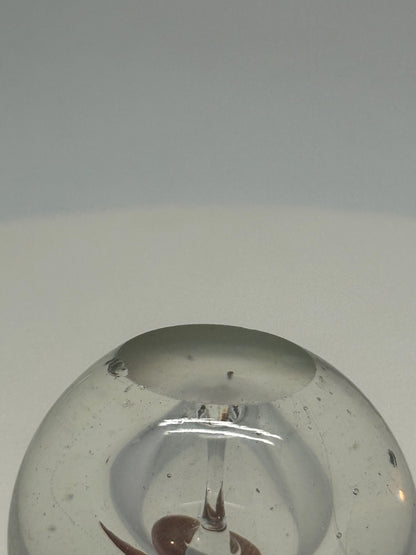 Artistic Clear Glass Sphere with Bubble Inclusions — fabric close-up