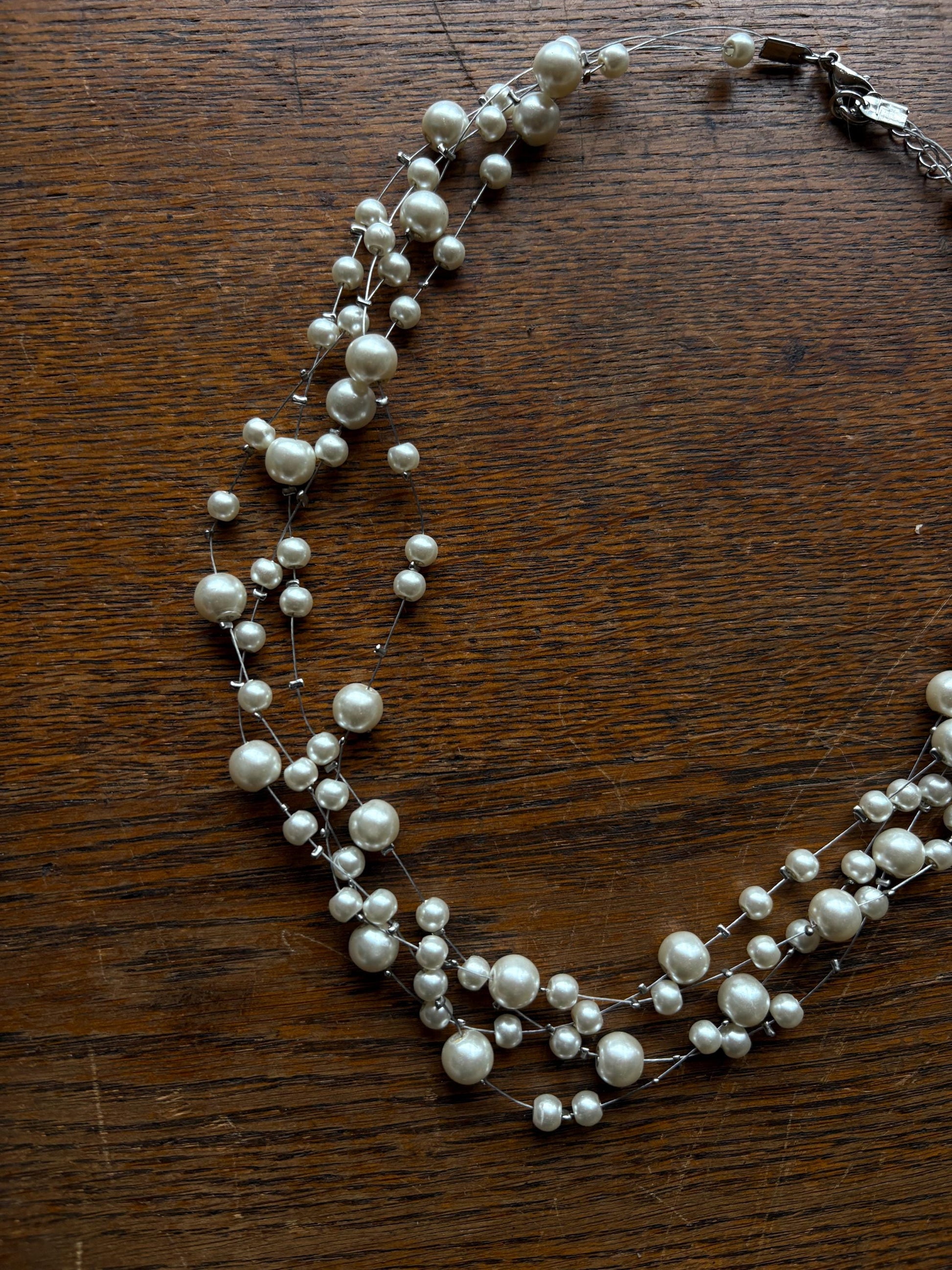 Elegant White Faux Pearl Necklace — fabric close-up