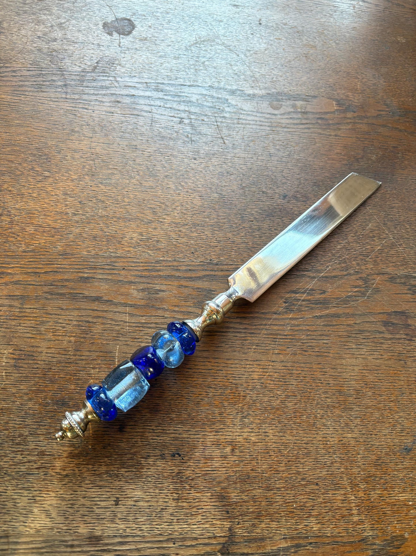 Ornate Silver Plated Butter Knife — fabric close-up