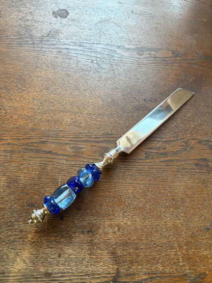 Ornate Silver Plated Butter Knife — fabric close-up