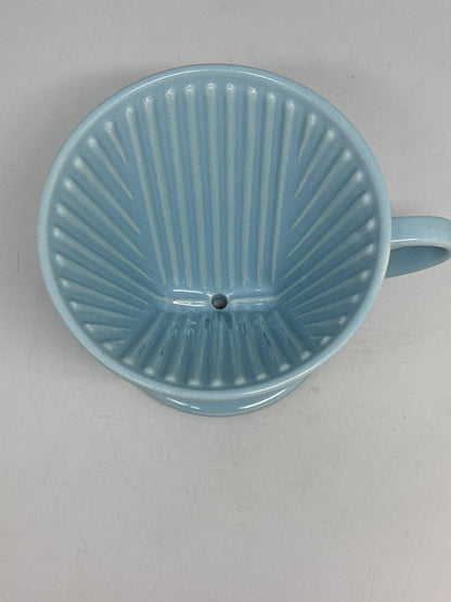 Vintage Blue Porcelain Melitta 102 Coffee Dripper — fabric close-up