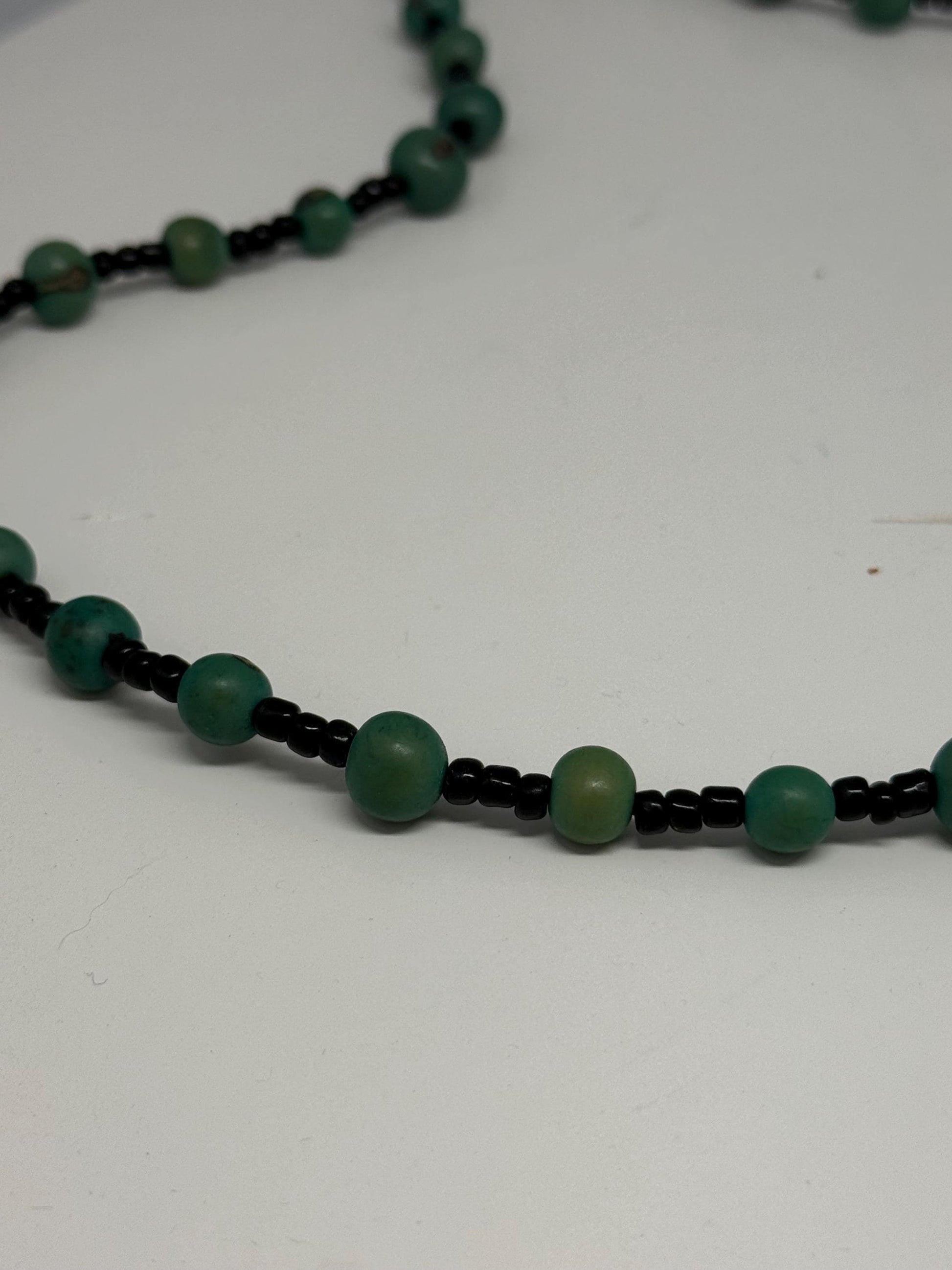 Vintage Green Beaded Seed Necklace — fabric close-up