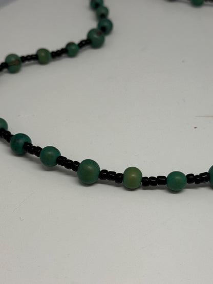 Vintage Green Beaded Seed Necklace — fabric close-up