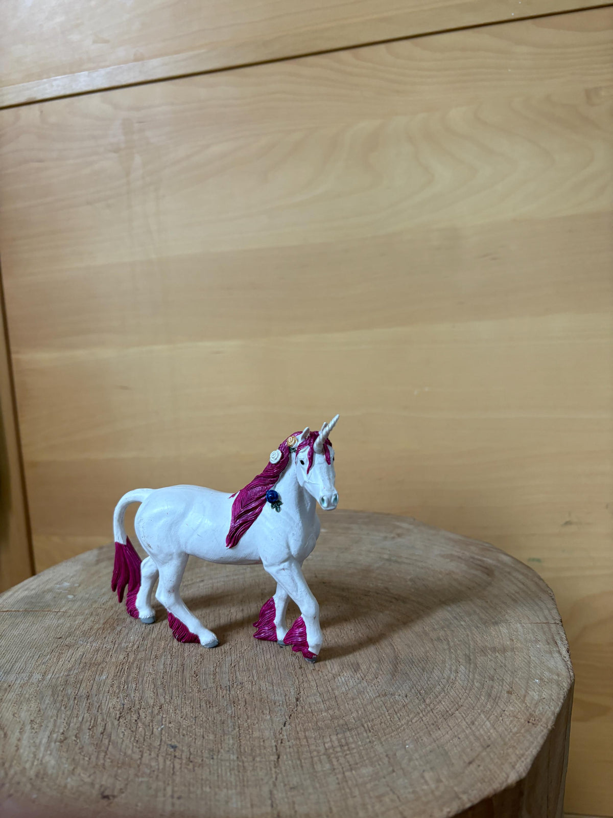 Pink Unicorn Figurine with Floral Details — fabric close-up