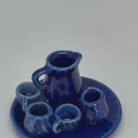 Vintage style blue ceramic miniature tea set, cobalt glaze, ribbed detailing, collectible decor piece, traditional aesthetic, decorative use