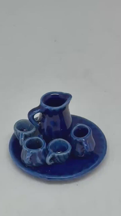 Vintage style blue ceramic miniature tea set, cobalt glaze, ribbed detailing, collectible decor piece, traditional aesthetic, decorative use